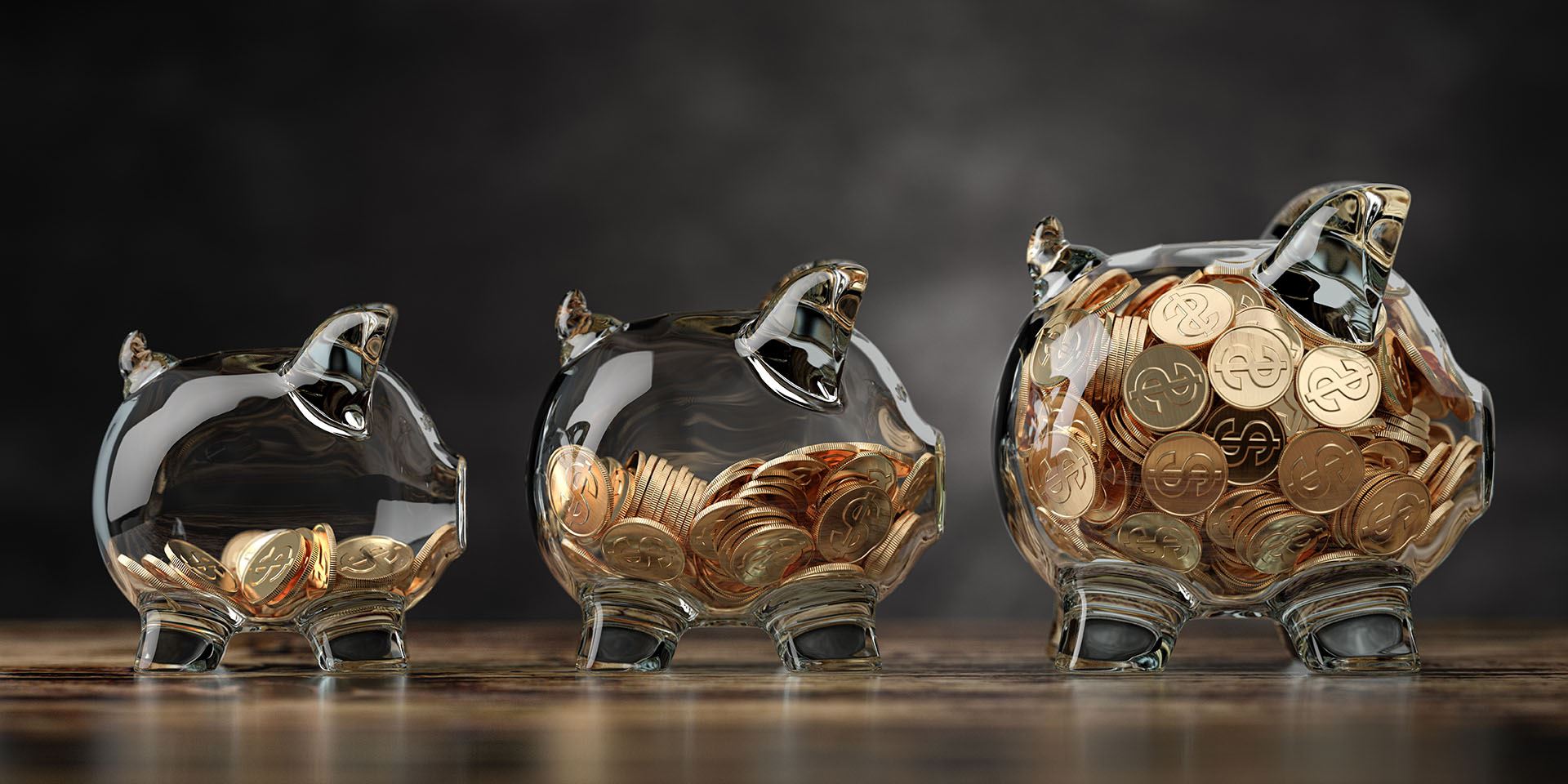 clear piggy banks with gold coins inside